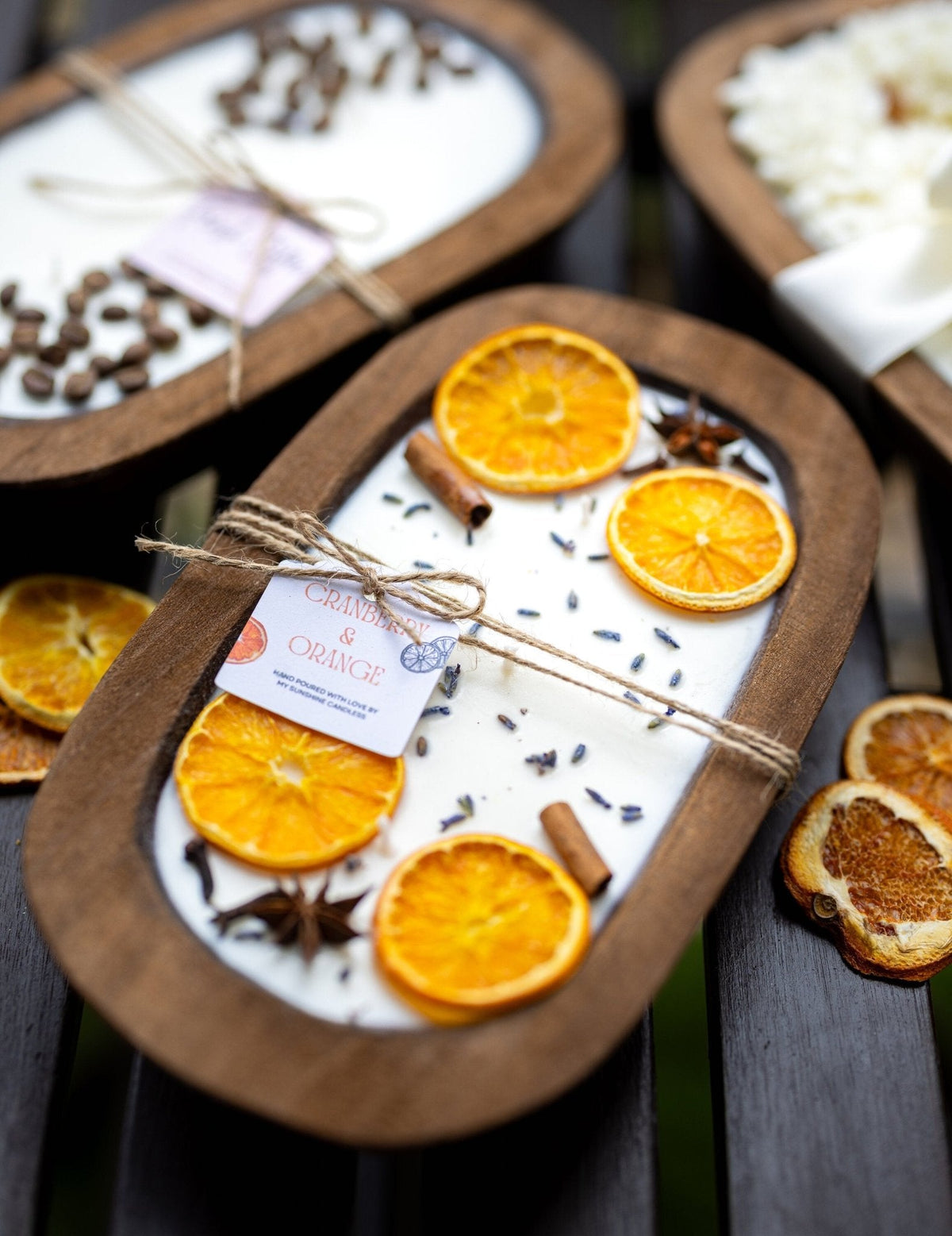 Soy candle in dough bowl with orange slices, cinnamon sticks, and anise stars