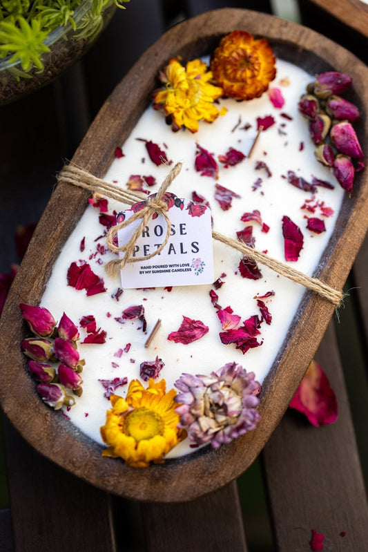 Wooden dough bowl soy candle with floral petals and rose-labeled wick tags