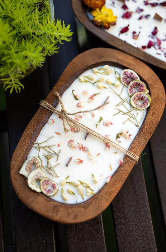 Wood dough bowl candle with white wax and dried herb and fig-slice decoration
