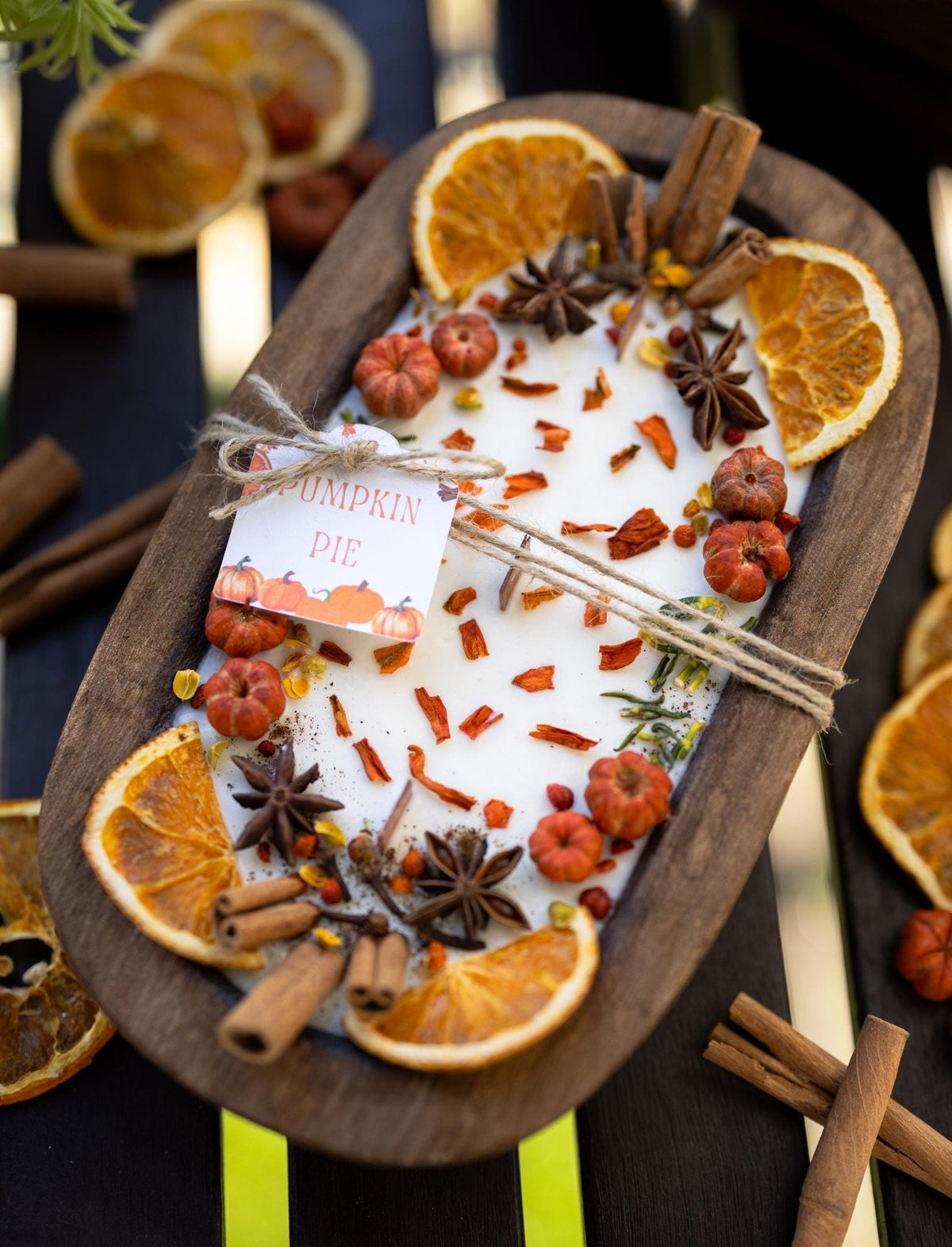 Large wooden candle bowl with pumpkin spice wax, orange slices, star anise and cinnamon sticks