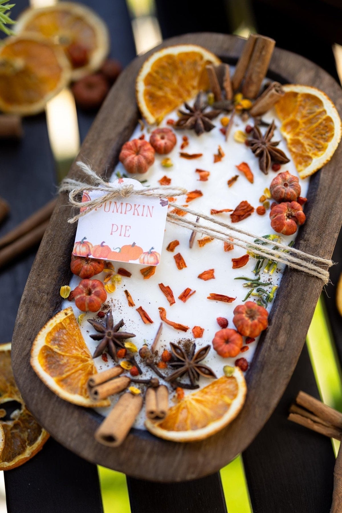 Large wooden candle bowl with pumpkin spice wax, dried orange slices, cinnamon sticks