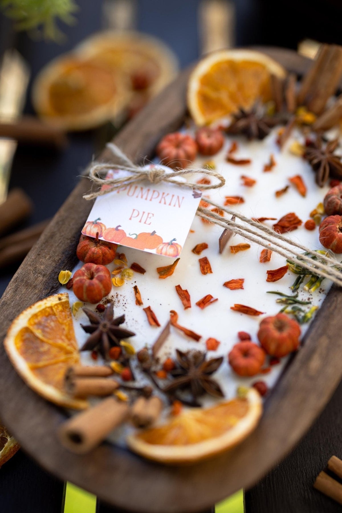 Large wooden candle bowl with pumpkin spice wax, dried orange slices, star anise and cinnamon