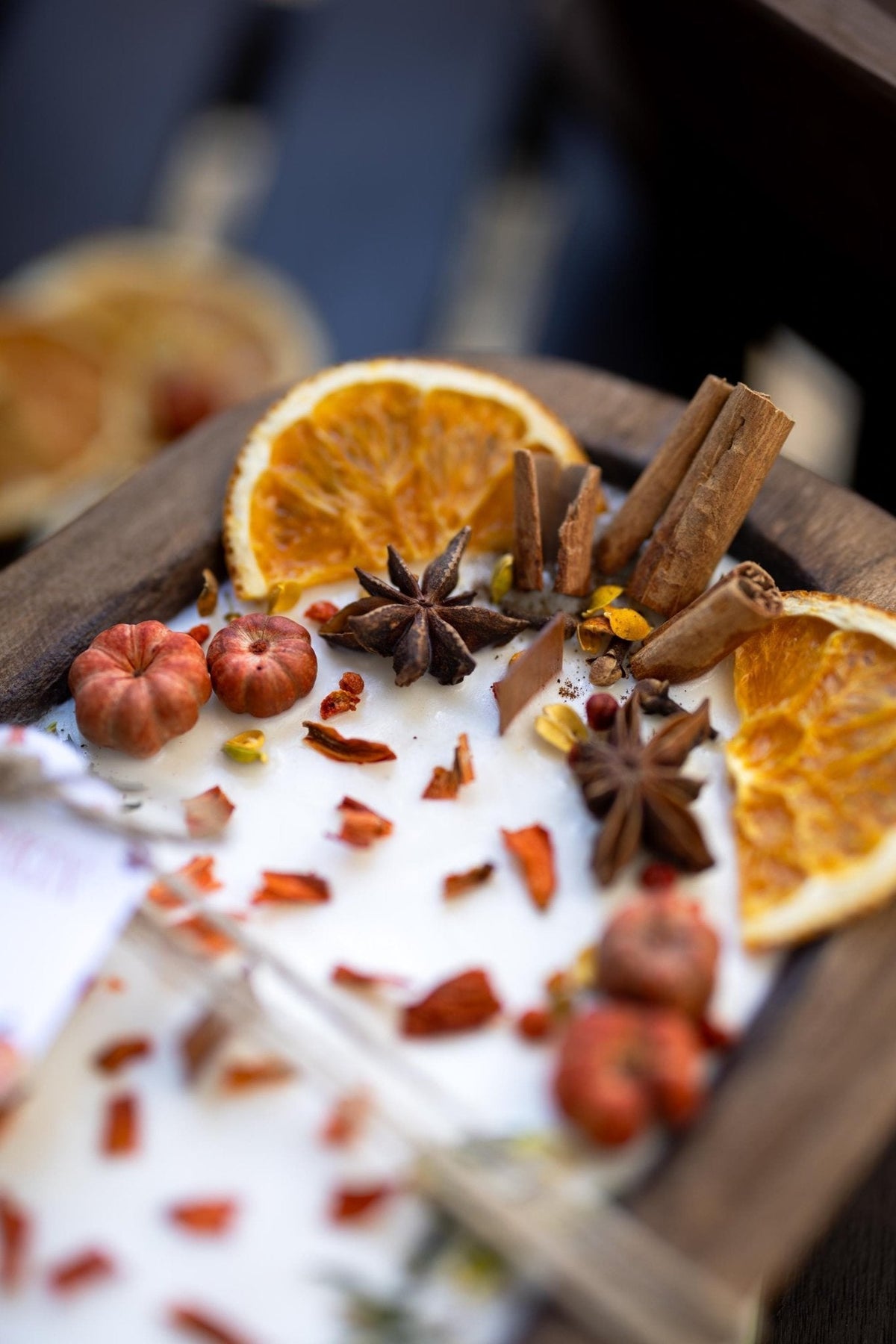 Large wooden candle bowl with pumpkin spice wax, orange slices, star anise, cinnamon sticks