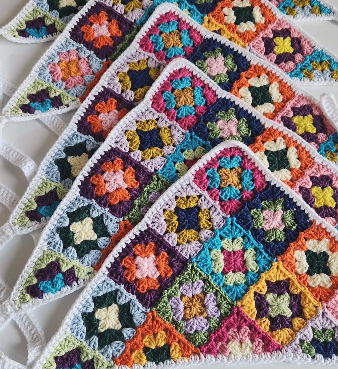 Crochet bandana with multicolor granny square panels and white border trim