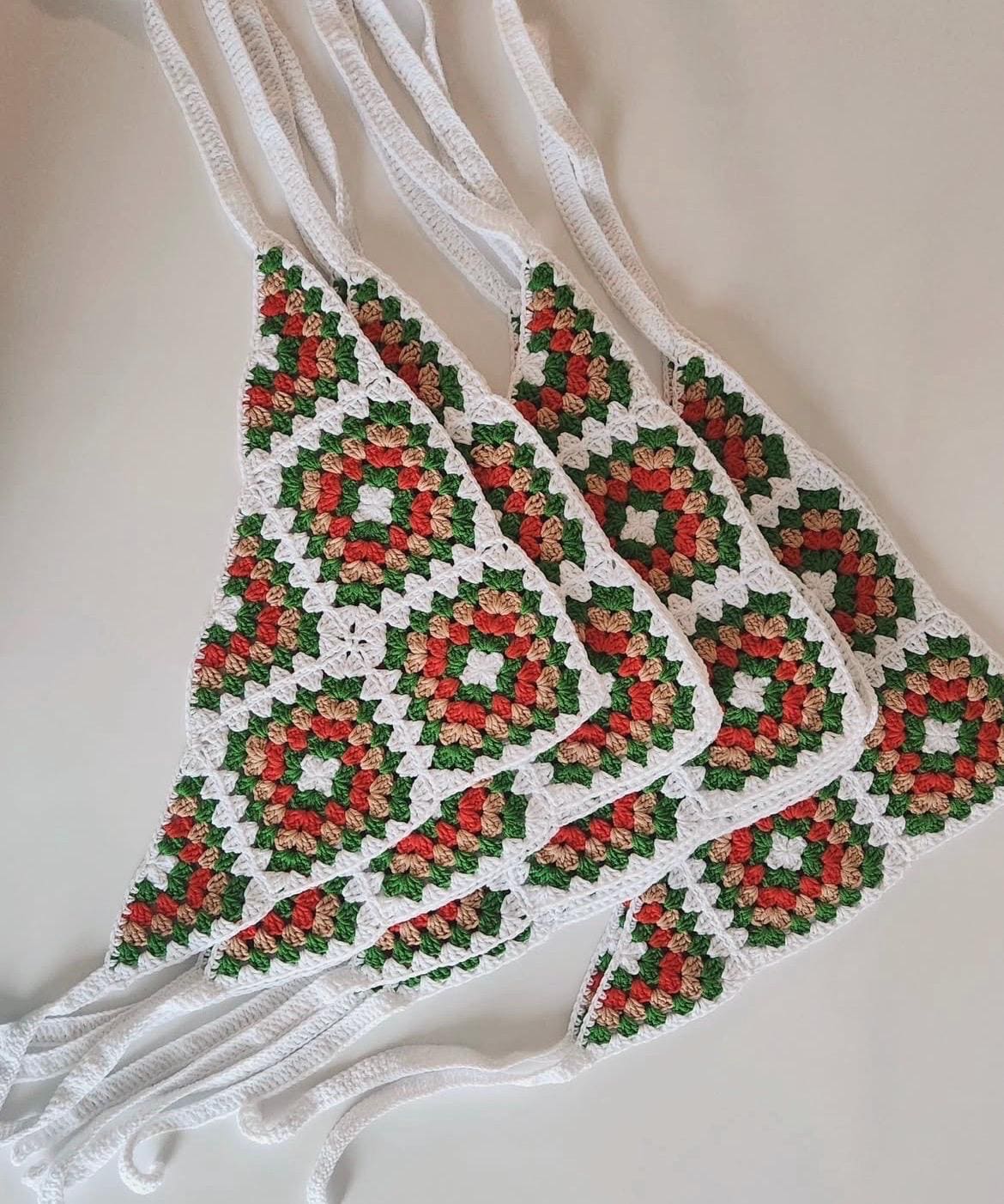Crochet granny square bandana with red, green, and beige squares and white border