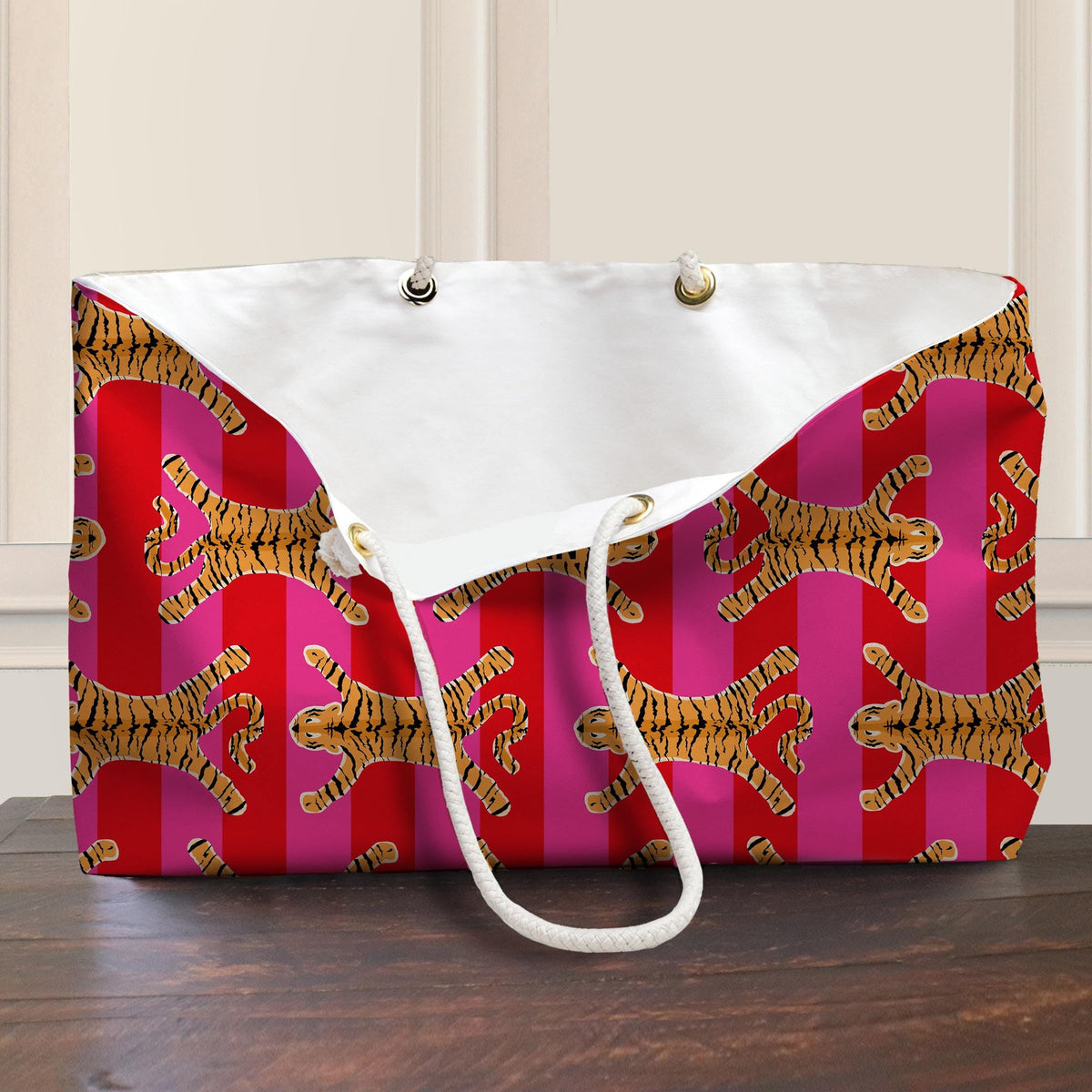 Open tiger-print tote bag with white rope handles and white lining
