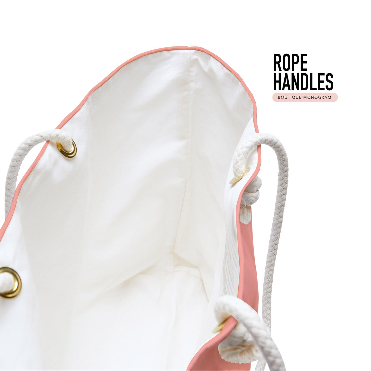 Tote bag interior with white rope handles, brass grommets, and coral edging