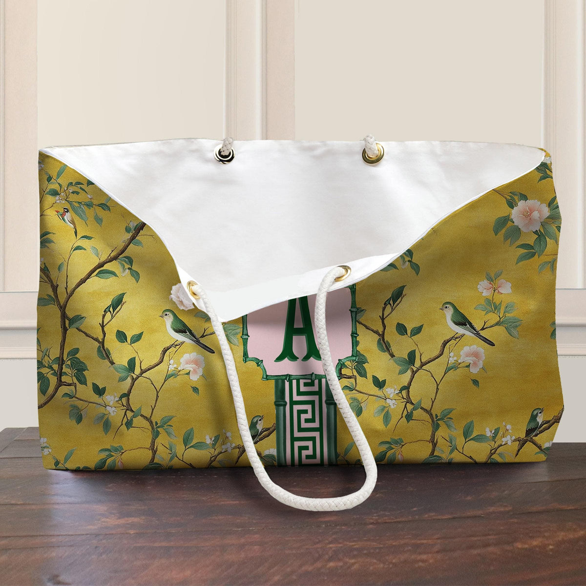 Open yellow mahjong tote bag with white rope handles and printed bird-and-floral design