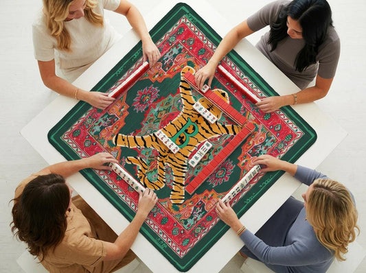 Mahjong mat with orange tiger graphic and ornate red and green pattern, shown with players