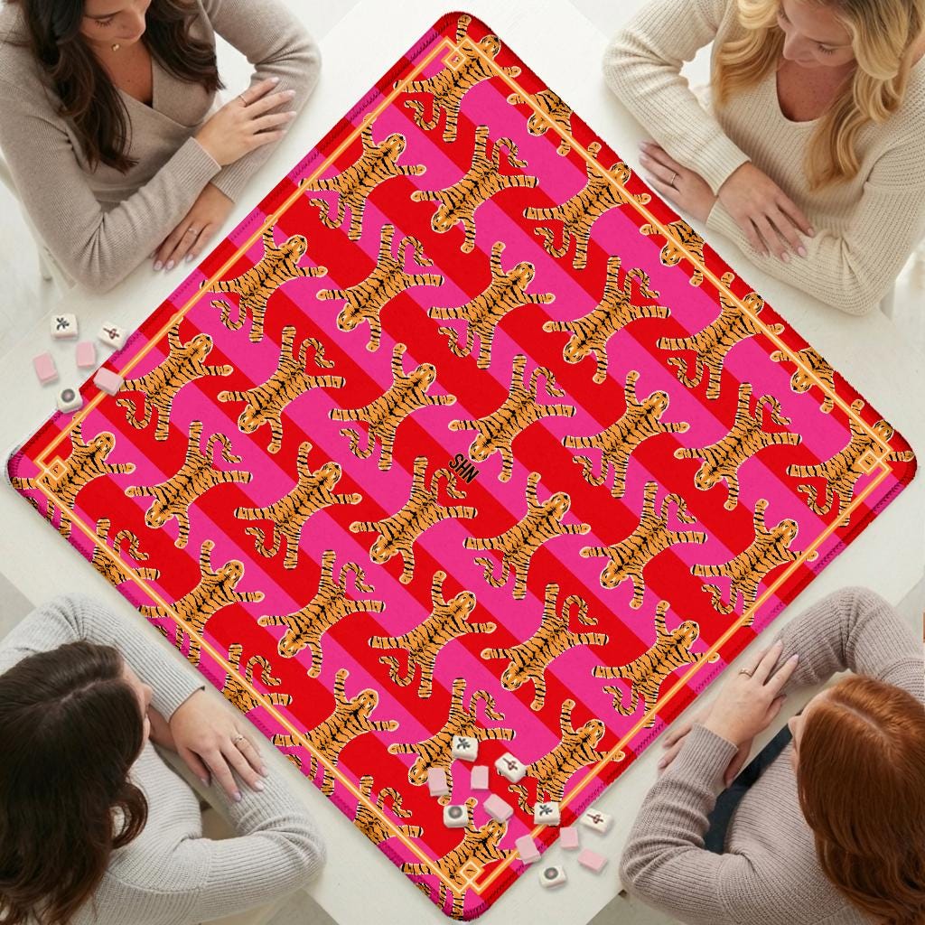 Custom Mahjong mat with a vivid pink and red tiger print and decorative gold edging.