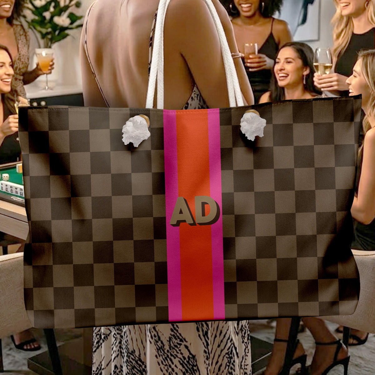 Brown checkerboard mahjong tote bag with white rope handles and a pink and coral monogram stripe