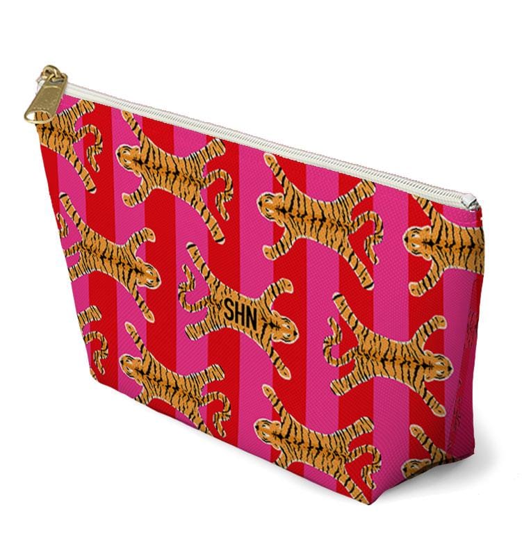 Angled view of a tiger-print mahjong bag with a white zipper and gold-tone pull