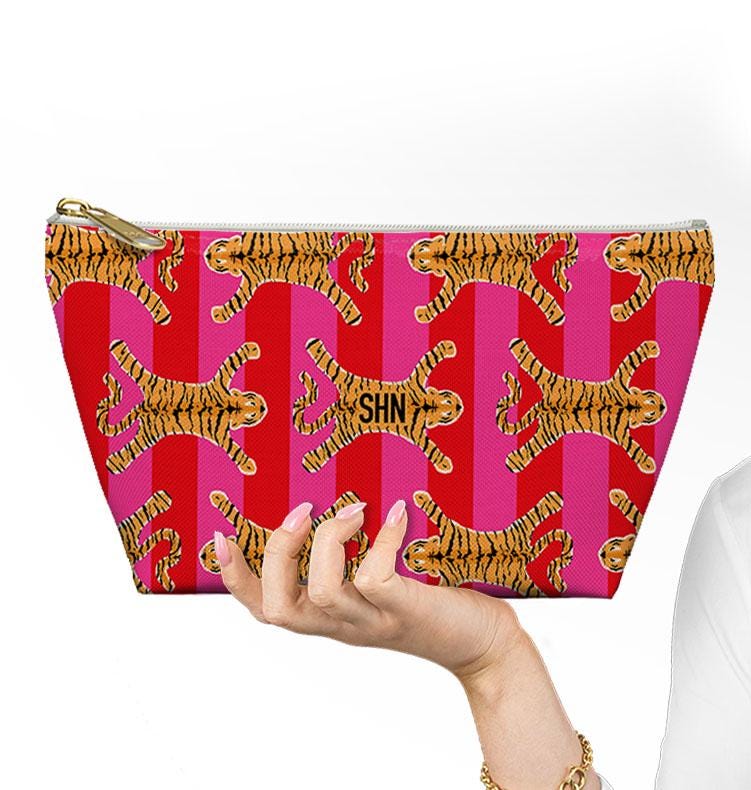 Tiger-print mahjong bag held up to show its size and tapered shape