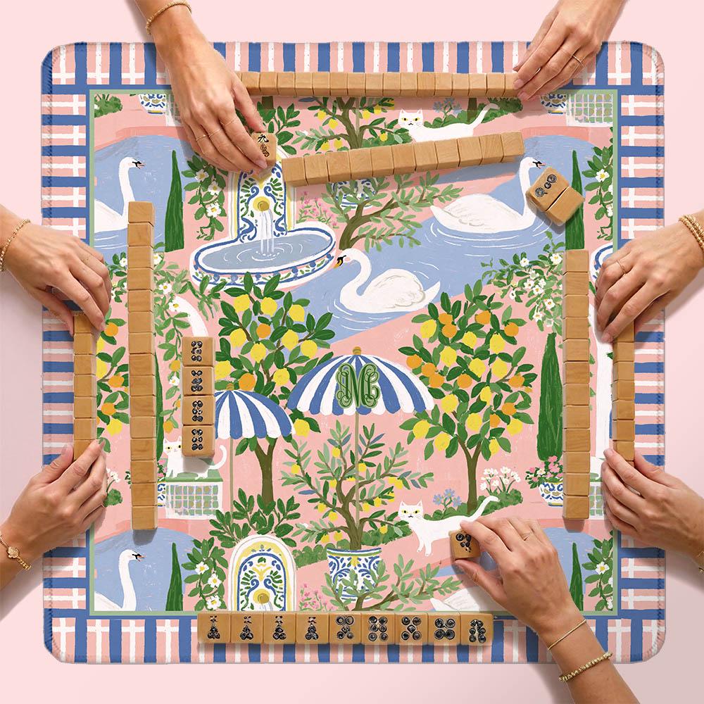 Custom mahjong mat with colorful garden print and plaid border, shown with tiles