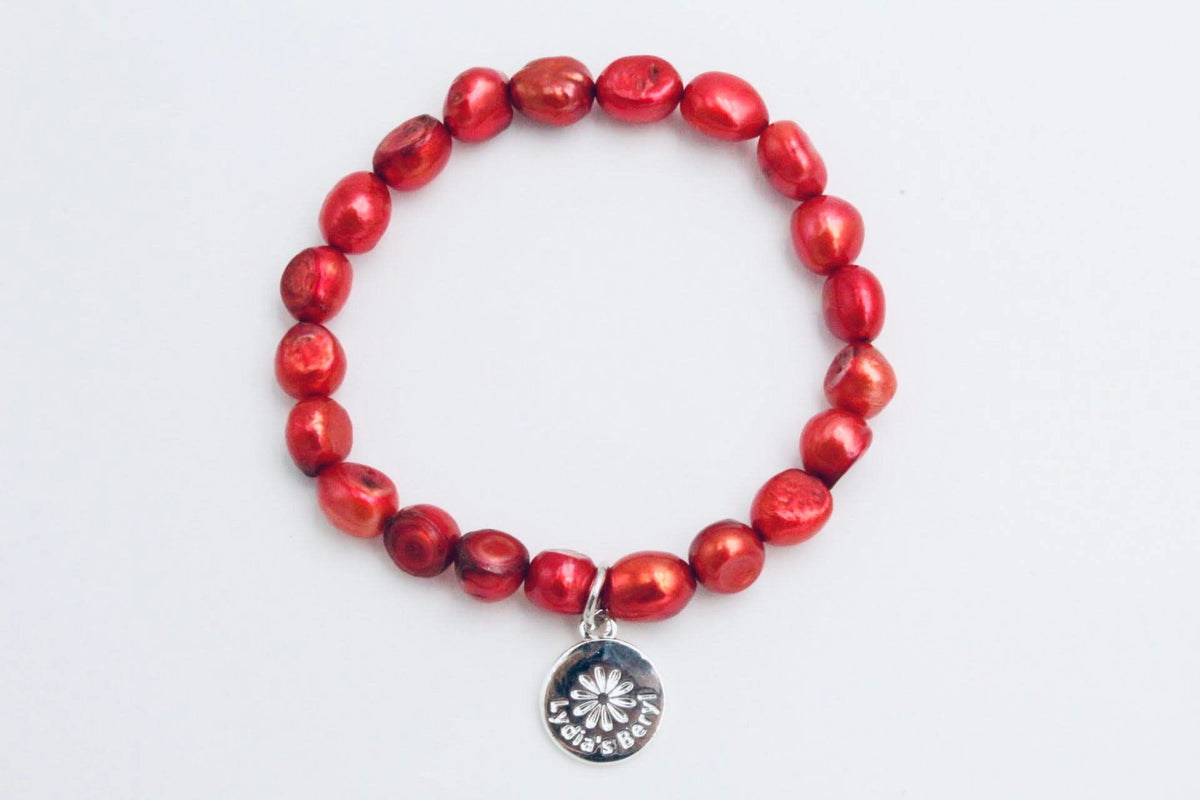 Red freshwater pearl bracelet with a silver-tone floral charm