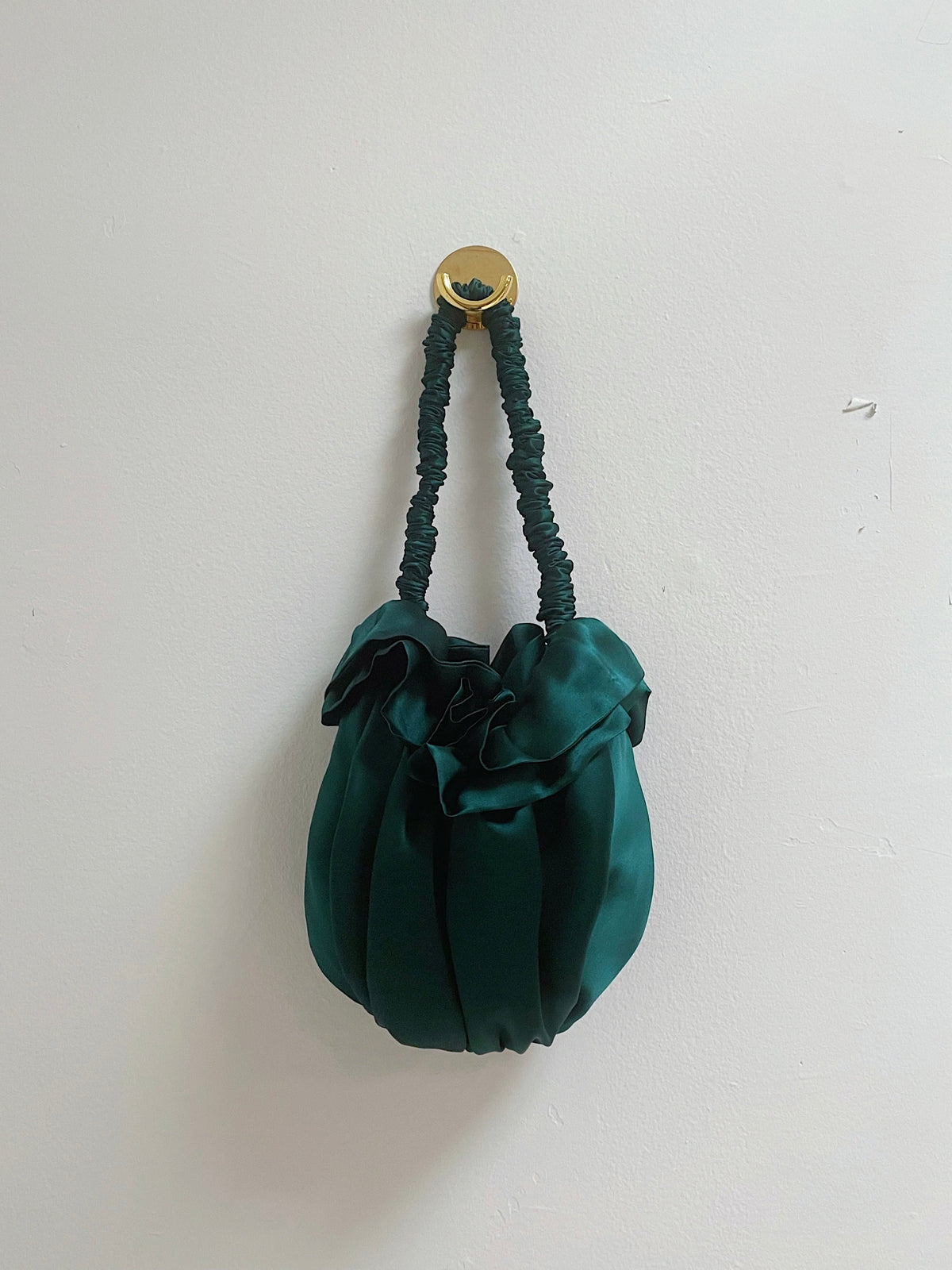 Deep green silk Bloom bag with a ruffled top and gathered handle