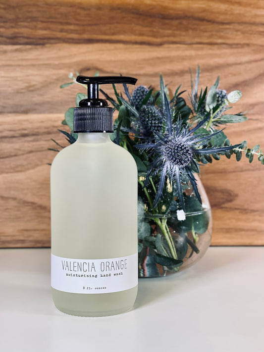 Valencia Orange hand wash bottle with black pump; white bottle and label