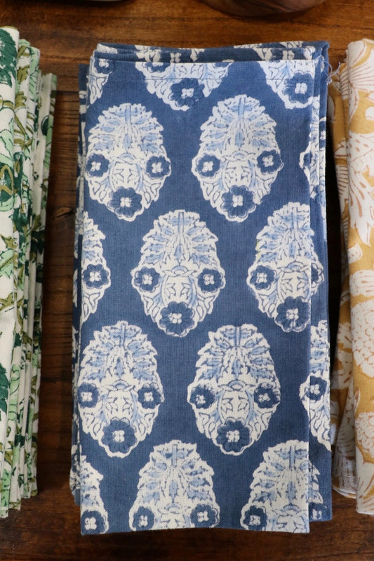 Botanical garden napkins in dark blue with white ornate floral medallion pattern, folded