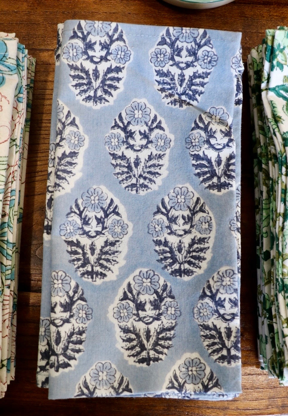 Botanical garden napkins in light blue with navy floral medallion pattern, folded rectangle