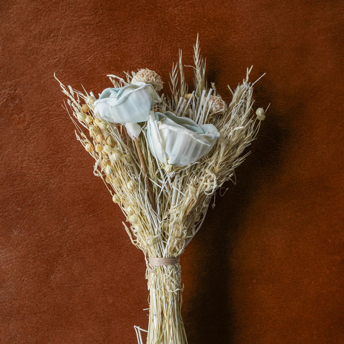 Dried floral and grasses bouquet with cream stems and pale blue rose accents
