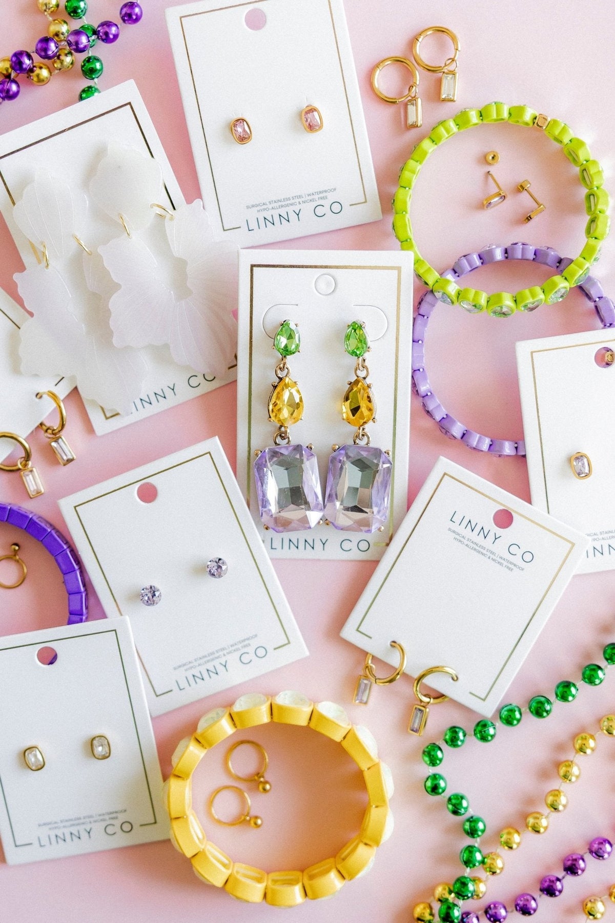 Green and yellow dangling statement earrings with purple faceted stones