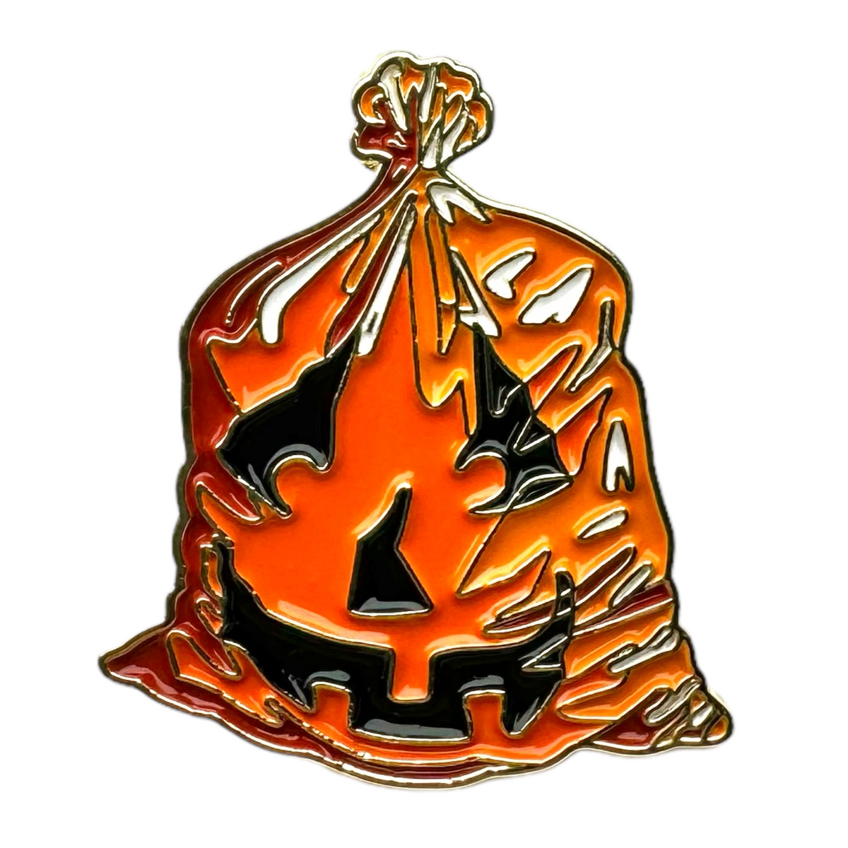 Enamel jack-o'-lantern leaf bag pin with orange pumpkin and black cutout design