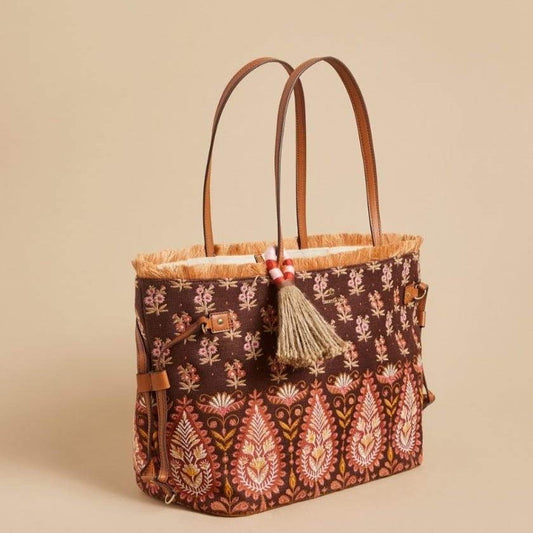 Brown boho paisley tote bag with fringed top, tan tassel, and leather handles