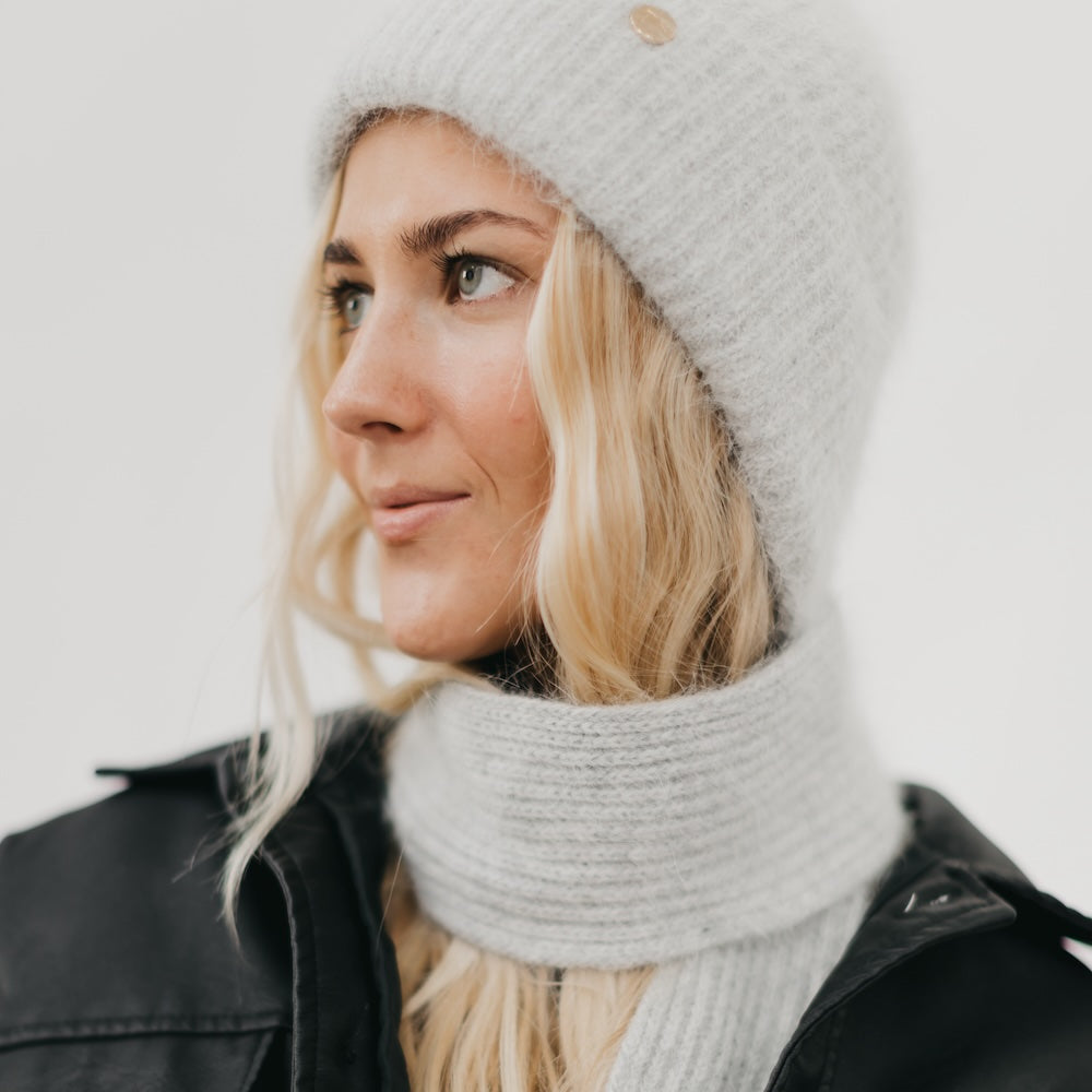 Light gray knitted beanie and matching scarf set with ribbed knit texture