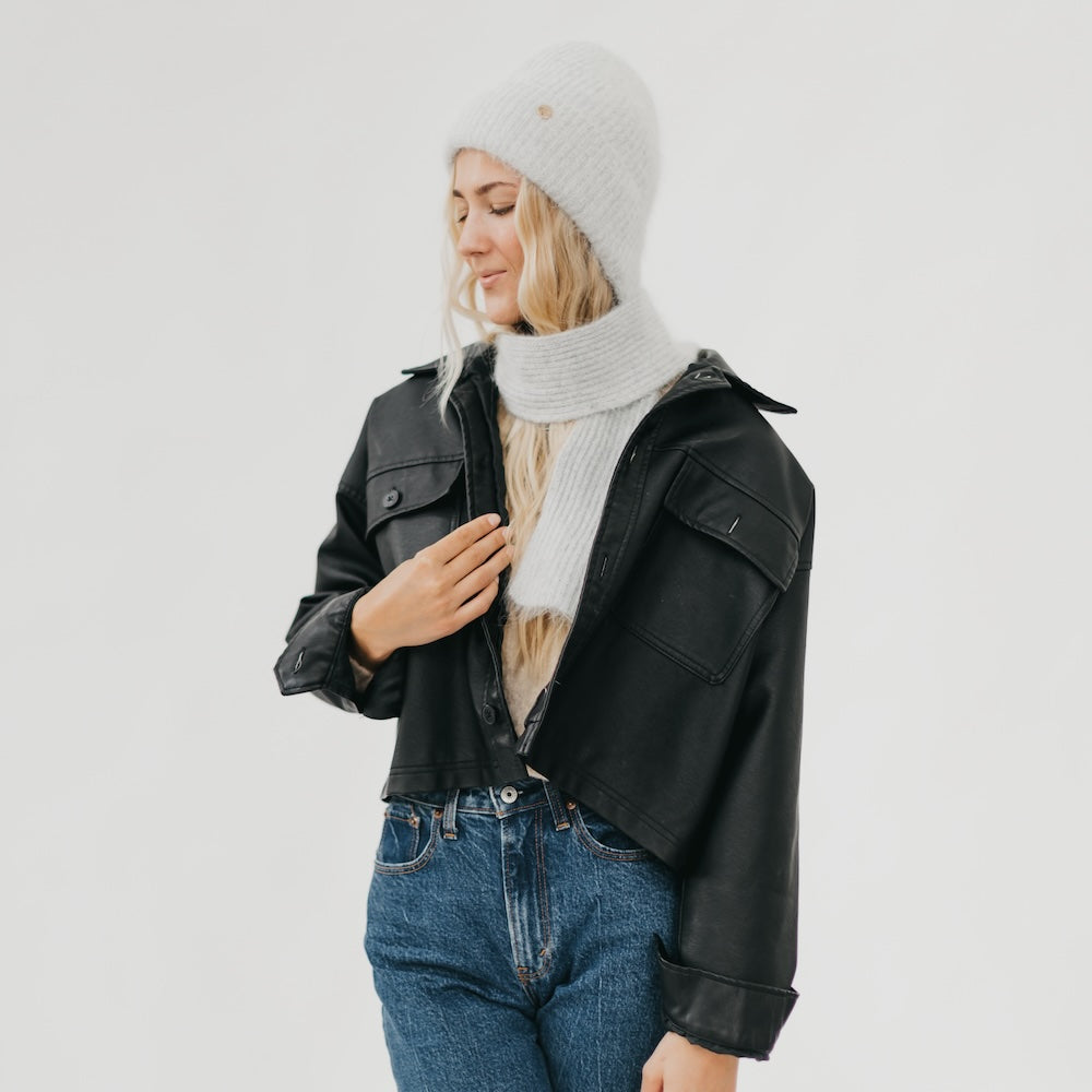 Light gray knitted scarf and beanie set with ribbed knit and round top badge