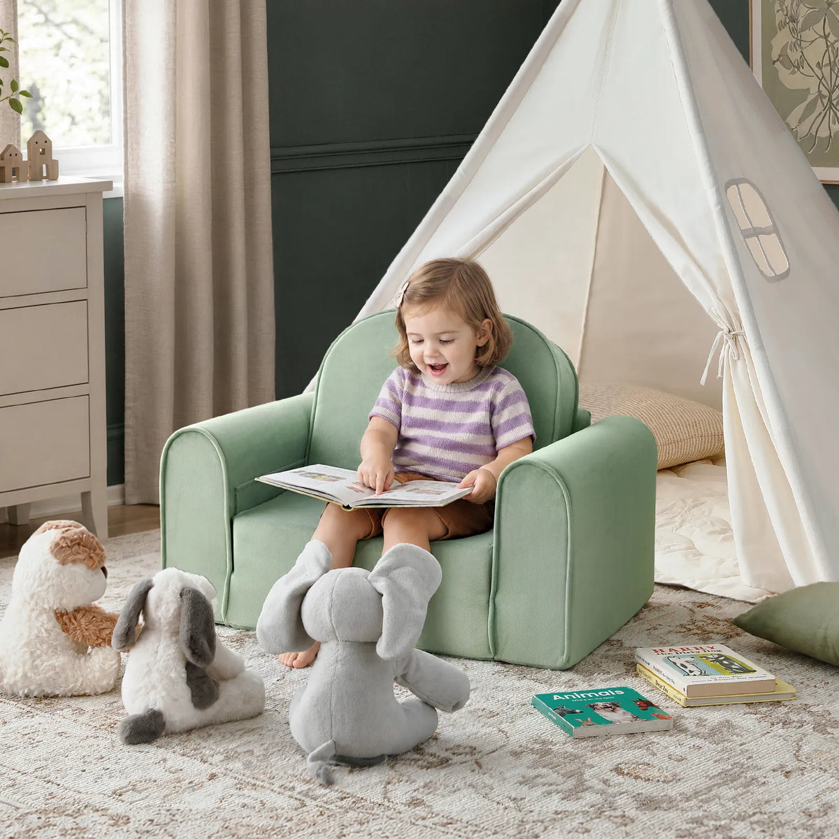 Tiny Land® light green kids sofa chair with a child reading, showing its rounded back and padded arms.