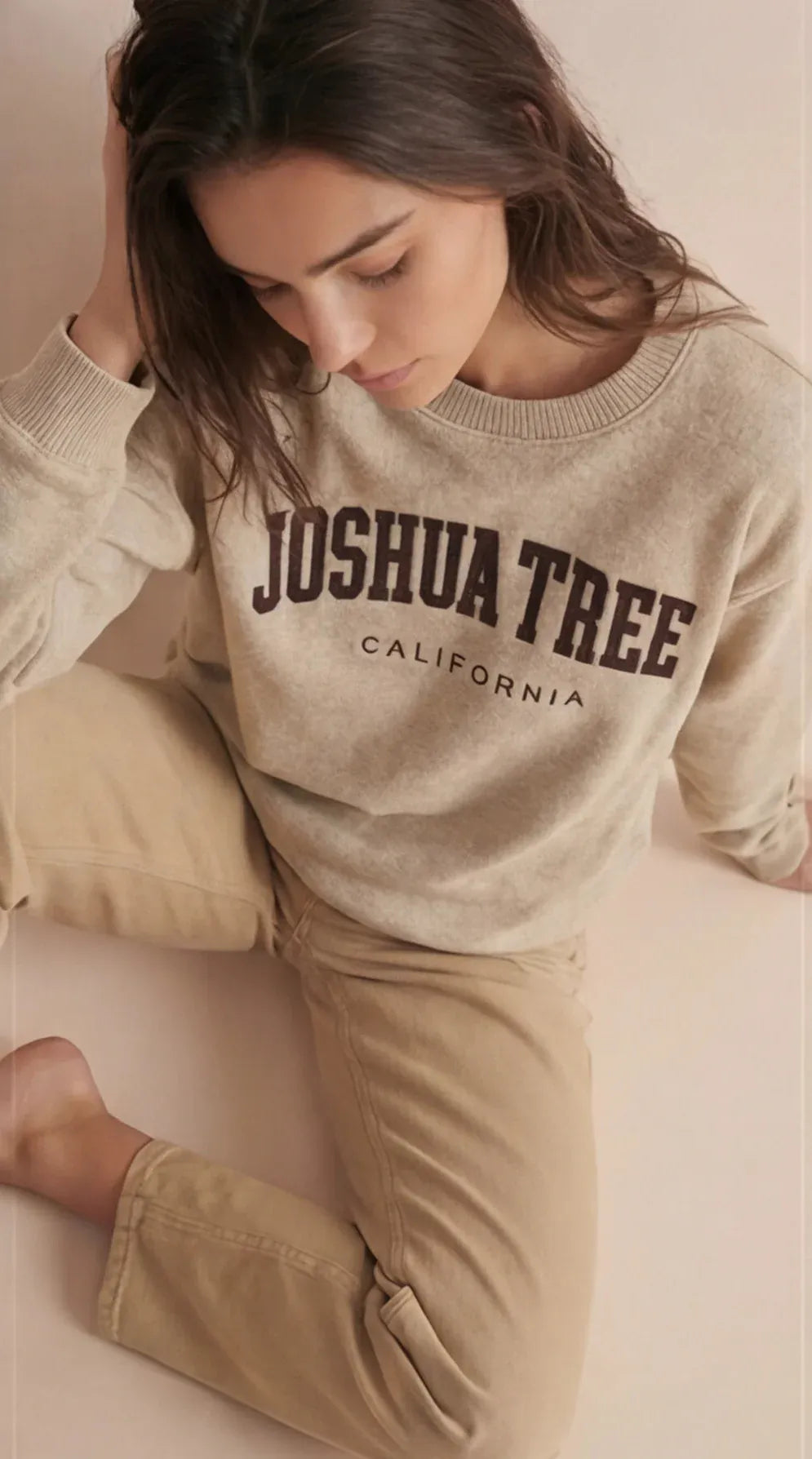 Beige crewneck sweatshirt with Joshua Tree California text graphic on the front