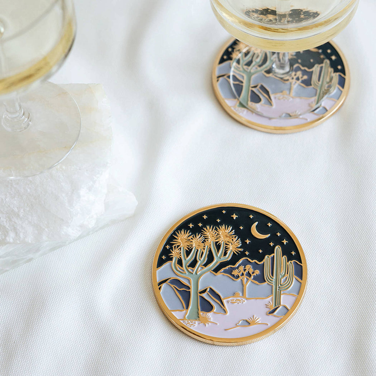 Round coaster with golden rim, desert cacti and starry sky illustration
