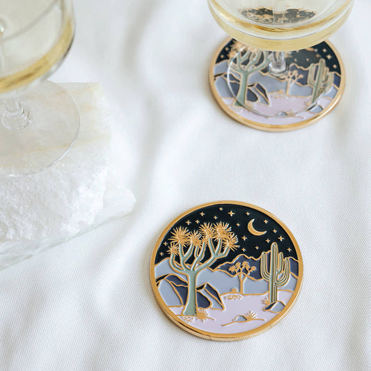 Round coaster with golden rim, desert cacti and starry sky illustration