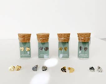 Leaf-shaped stud earrings set in gold and dark metallic tones
