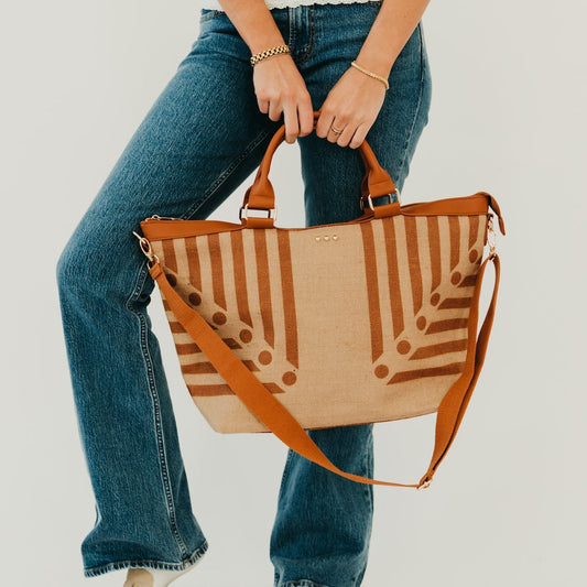 Jute tote bag with tan and brown vertical stripe print, brown handles and crossbody strap