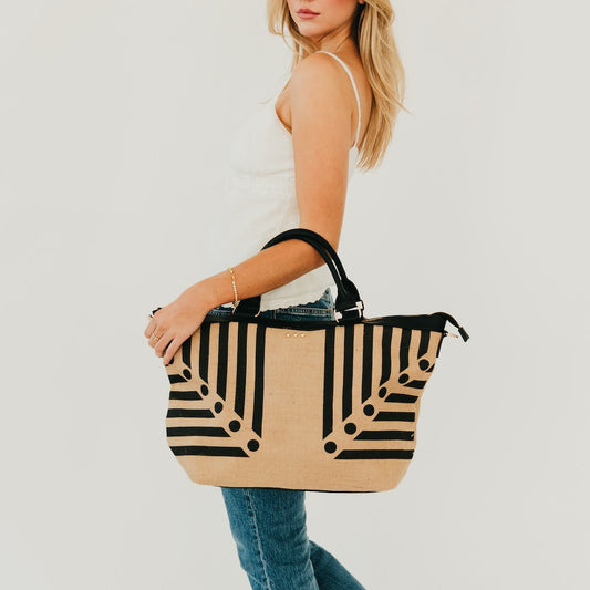 Jute tote bag with black and natural vertical stripe print, top handles and side pockets
