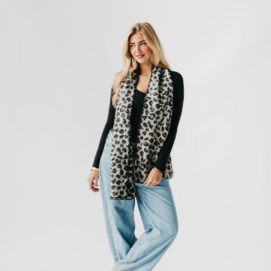 Leopard print scarf with black edge trim, hanging over the shoulder