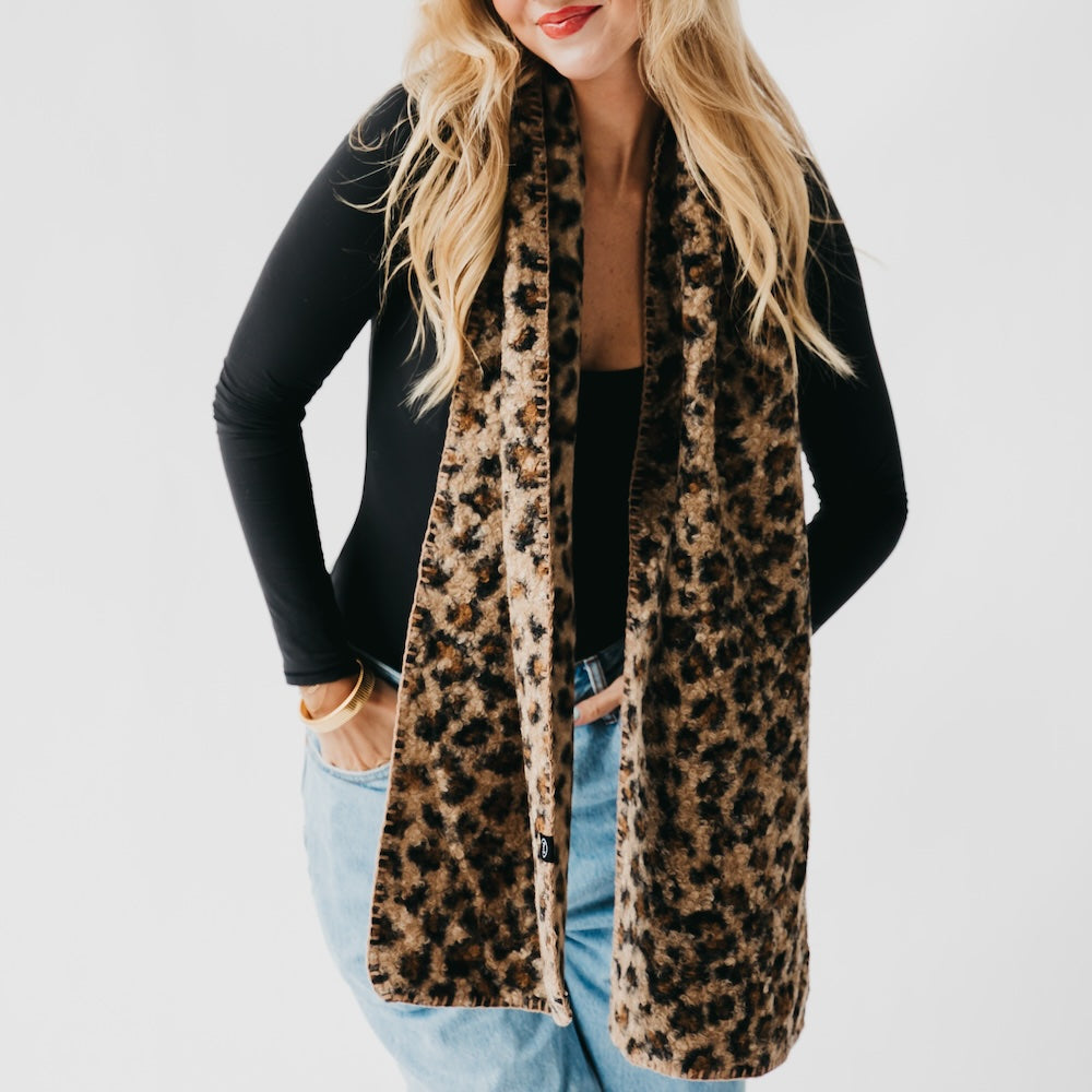 Leopard print scarf with black trim, long drape with a centered opening