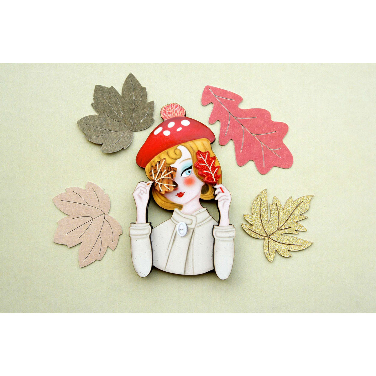 Laliblue autumn girl brooch with fall leaf accents, girl holding hands near hat