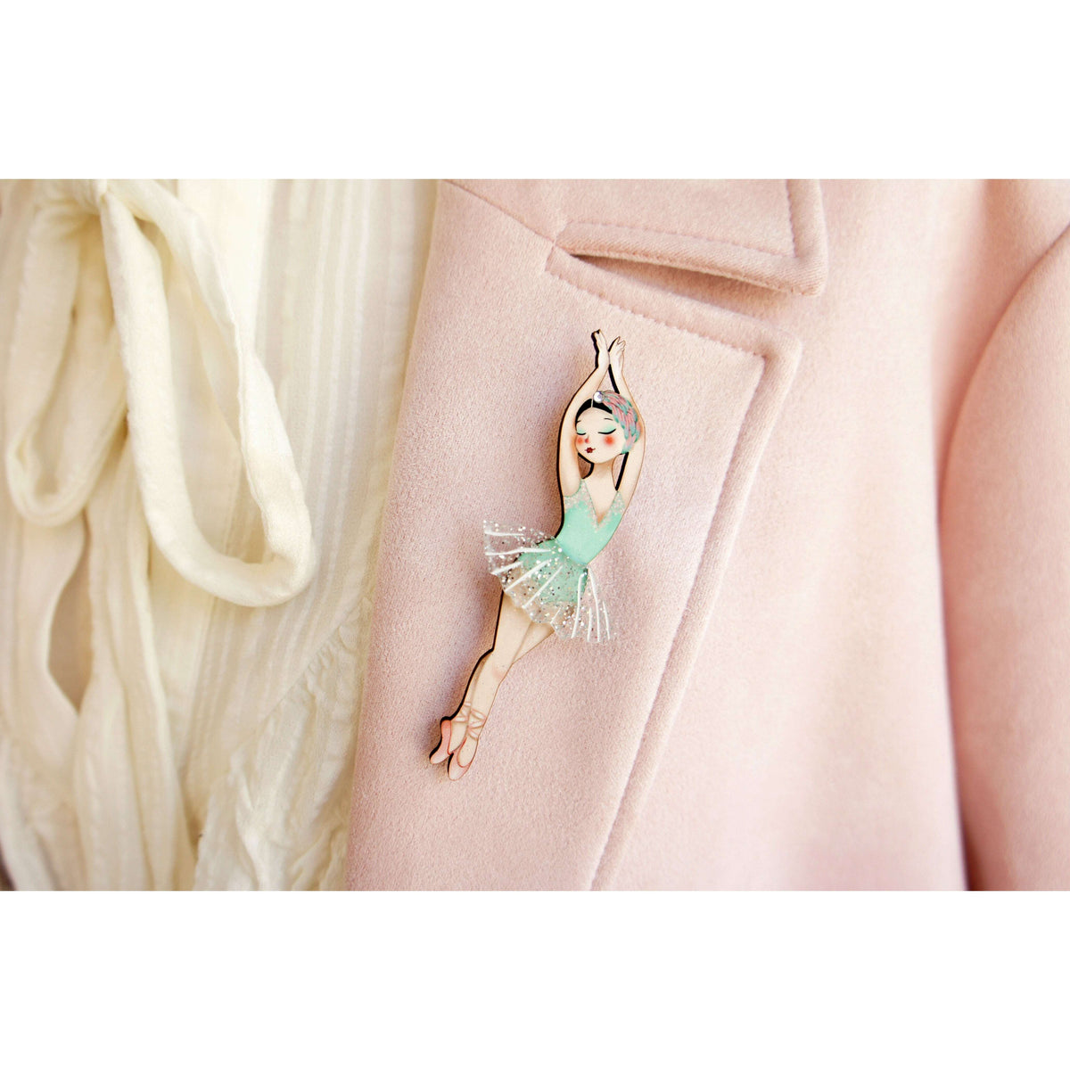 Ballerina brooch pin on pale pink coat lapel, turquoise leotard and glitter tutu