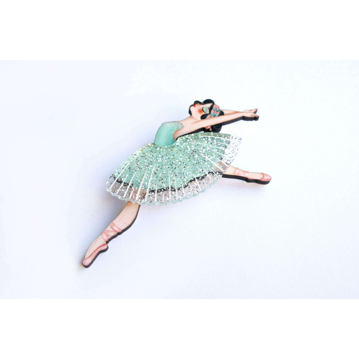 Teal-green ballet dancer brooch with sparkly silver tulle skirt and raised arm pose