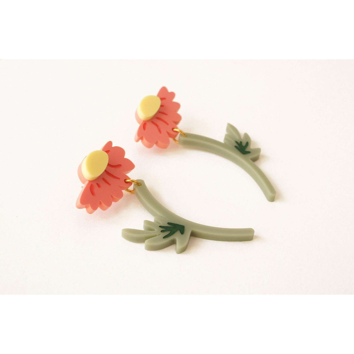 Pair of flower hoop earrings: pink blossoms, yellow centers, green leaves