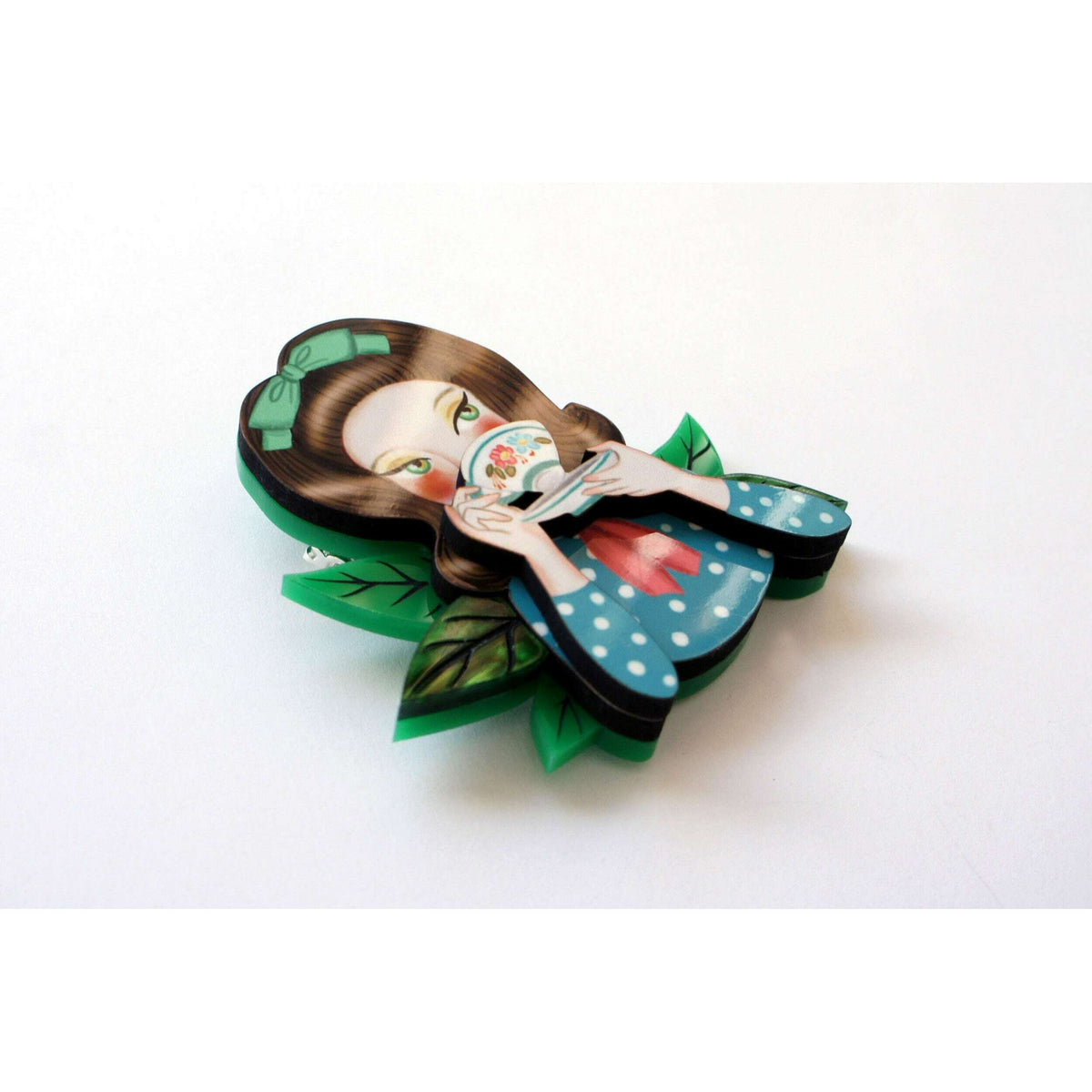 Girl tea-drinking brooch angled view with blue polka dress