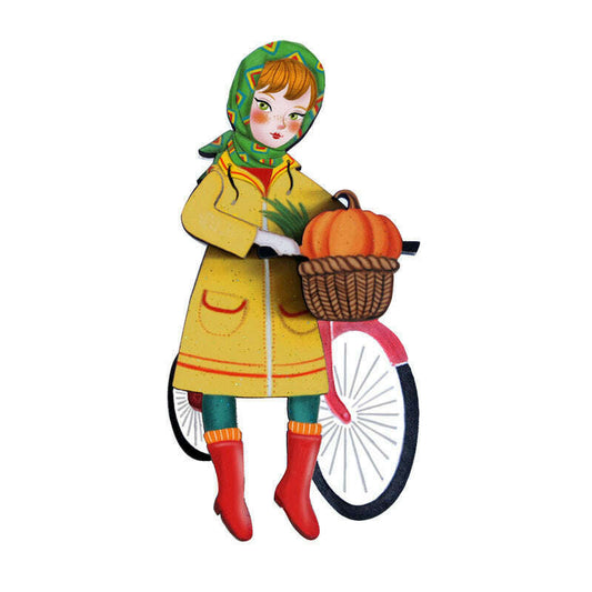 Girl bicycle brooch with hooded child, orange pumpkins in basket, and bike wheel charm