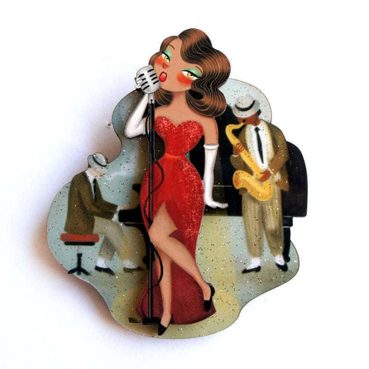 Jazz concert brooch: woman in red dress singing with microphone and band