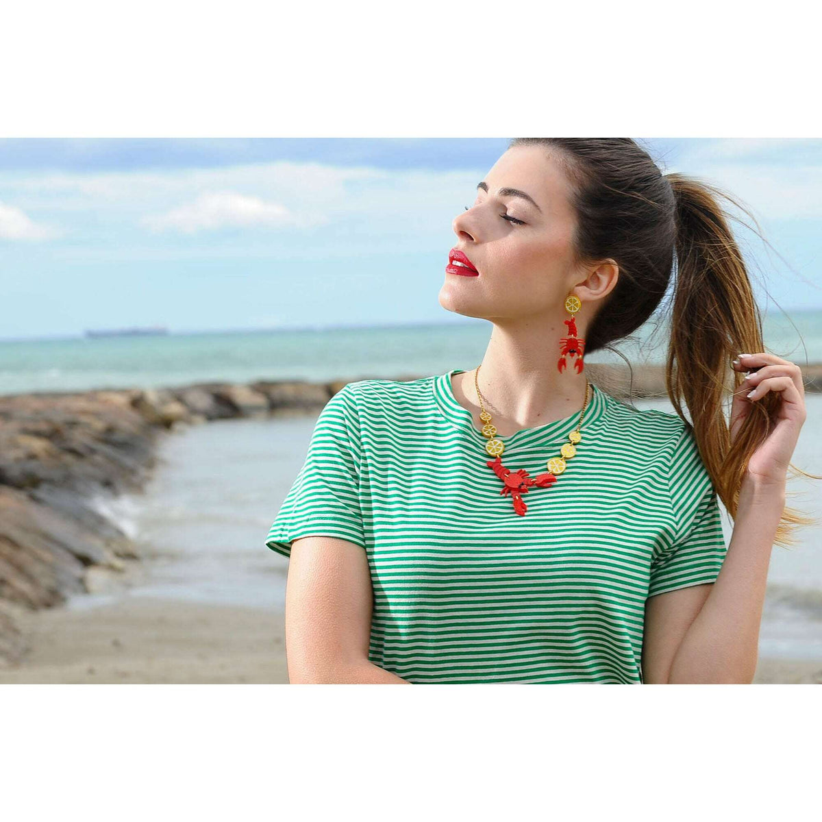 Lobster necklace worn: gold chain with red lobster charm and citrus bead accents