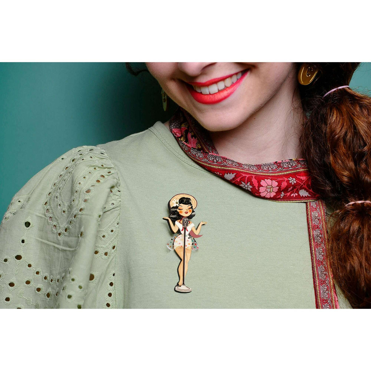 Pin-up singer enamel brooch worn on clothing, gold-tone microphone figure with polka dots