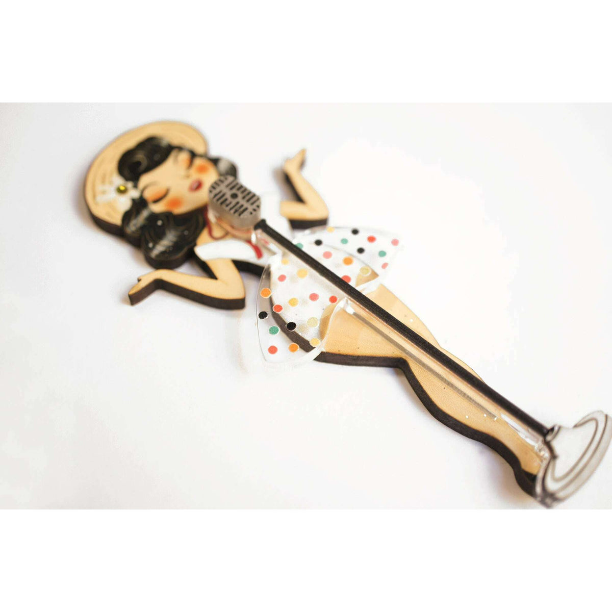 Pin-up singer enamel brooch laid flat, long microphone and polka-dot dress