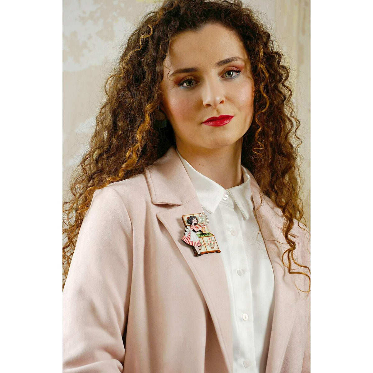 Tea pin up brooch worn on blazer lapel with illustrated pin-up woman tea motif