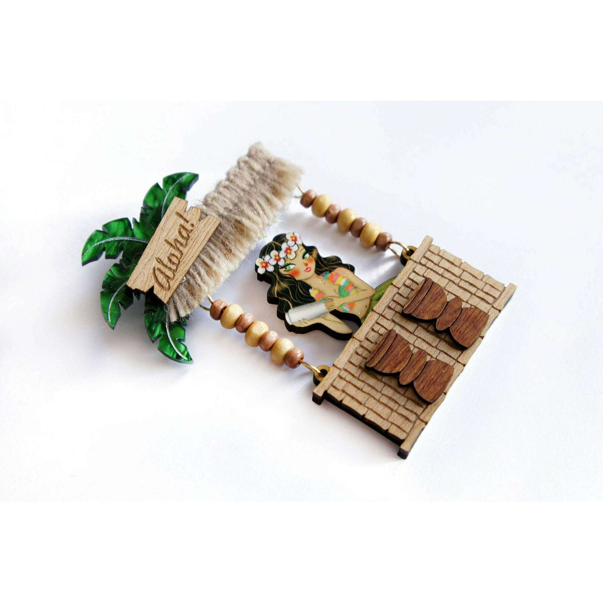 Laliblue tiki bar brooch angled view with palm leaves and wooden bar frame